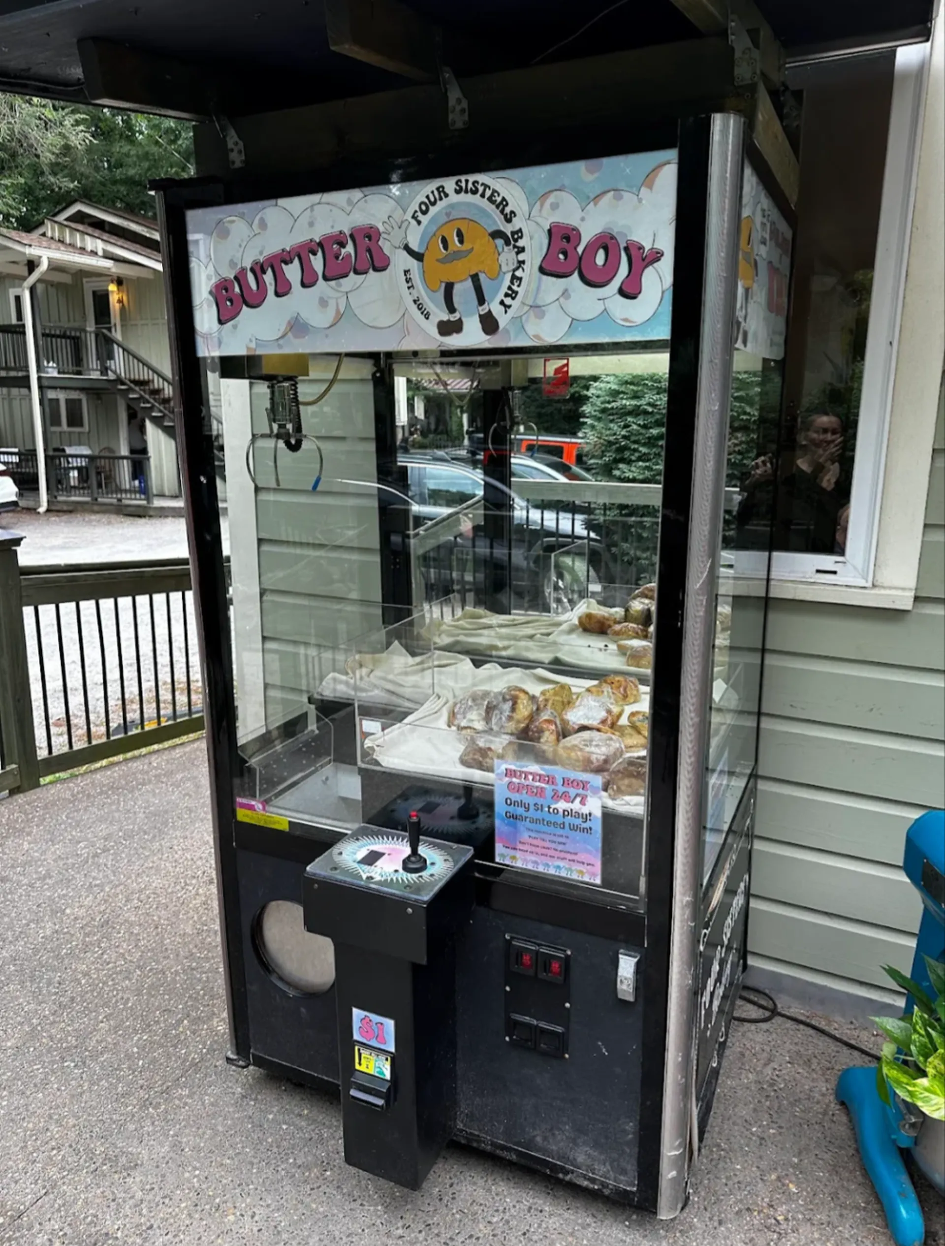 Butter Boy claw machine installed outside Four Sisters Bakery