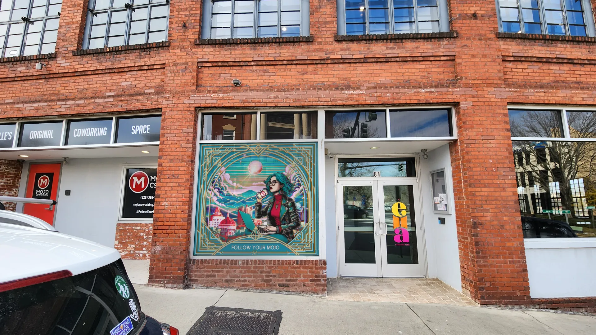 Mojo Coworking storefront with the window mural installed